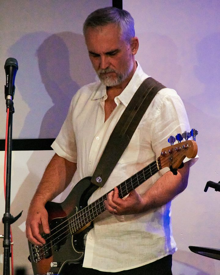 A bassist playing during worship